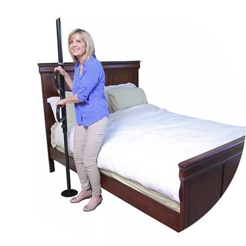 Older woman using a tranfer pole beside a bed