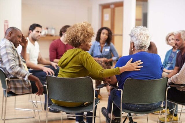 Group of people sitting and facing eachother