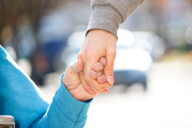 Two people holding hands