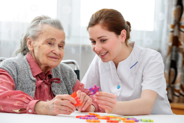 Nurse playing puzzle with an elderly woman