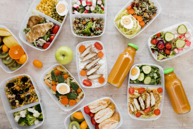 Different meals on containers and juice on bottles