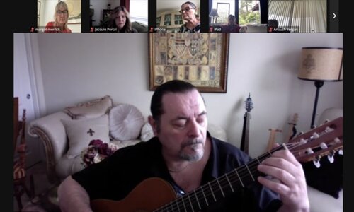 Man playing the guitar during zoom call